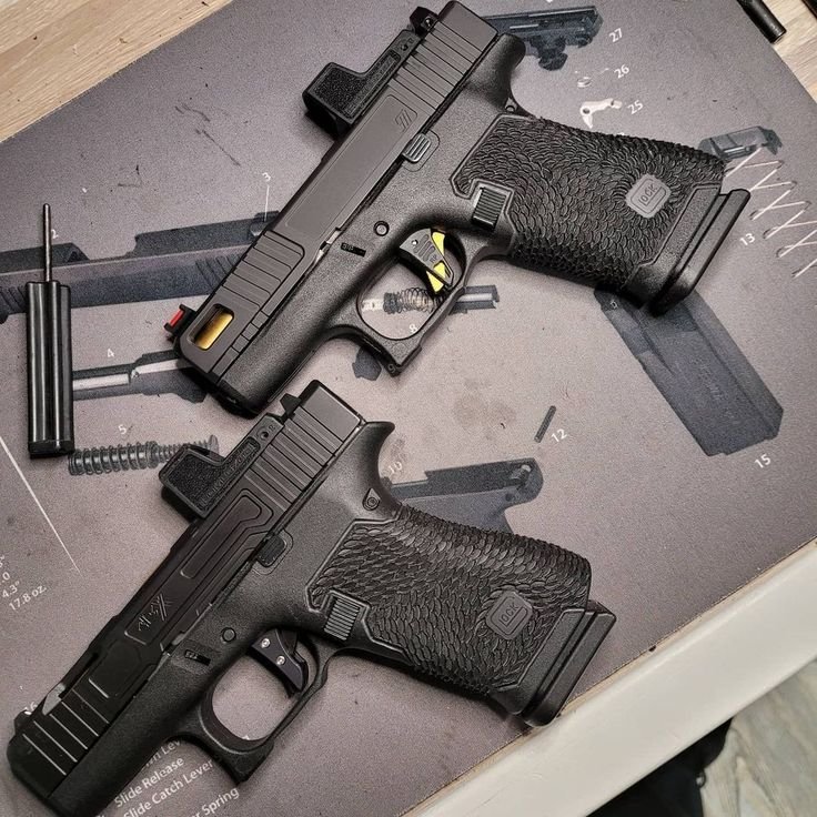 A sleek black GLOCK 17 semi-automatic pistol showcased against a dark backdrop.